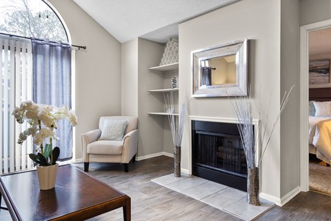 A living room with a fireplace and a chair.
