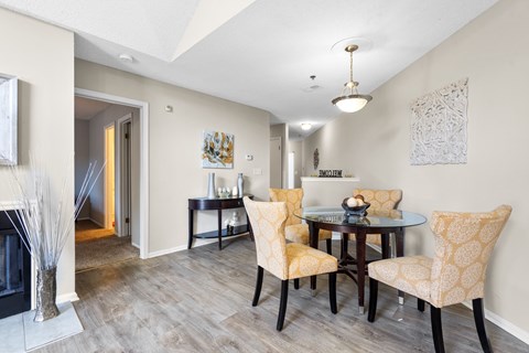 A dining room with a table set for four.