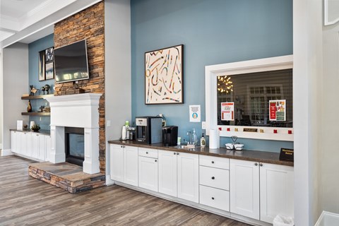 A living room with a fireplace and a painting on the wall.