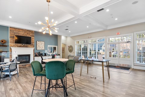 A living room with a fireplace and a dining table set up.