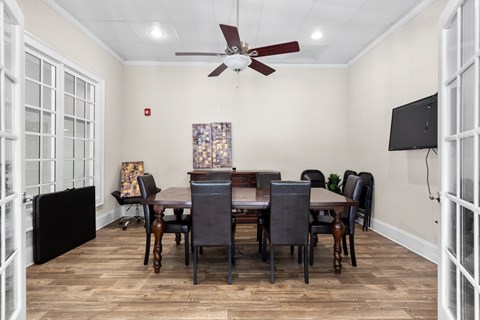 A dining room with a wooden table and chairs.