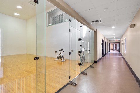 A room with a wooden floor and a glass wall.