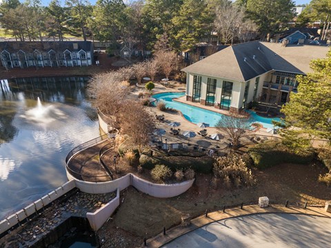 A house with a pool and a waterfall in the backyard.