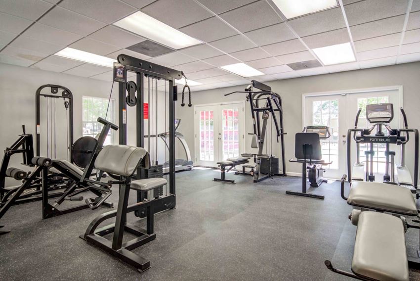 a gym with weights and other equipment in a building