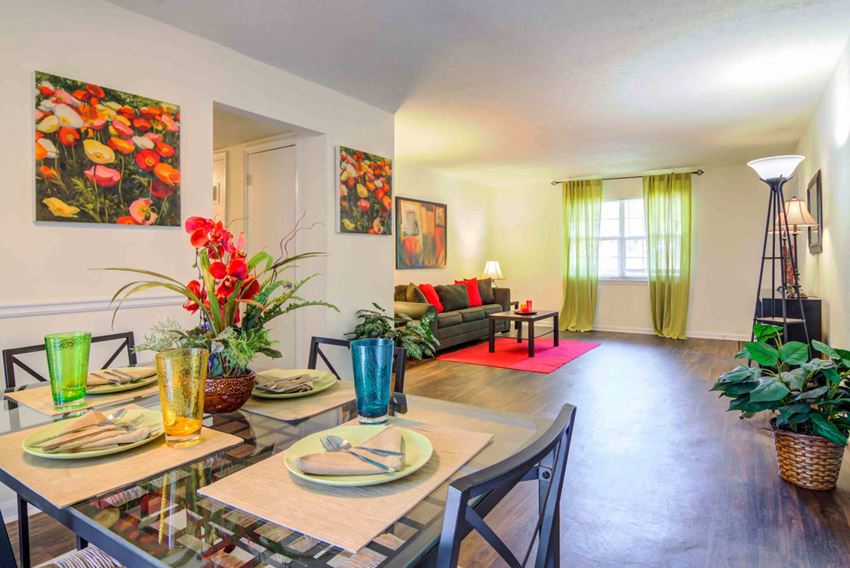 a living room and dining room with a table and chairs