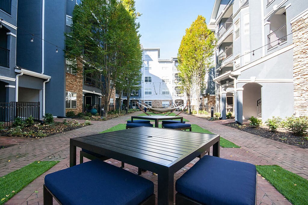A table and chairs are set up on a brick patio.