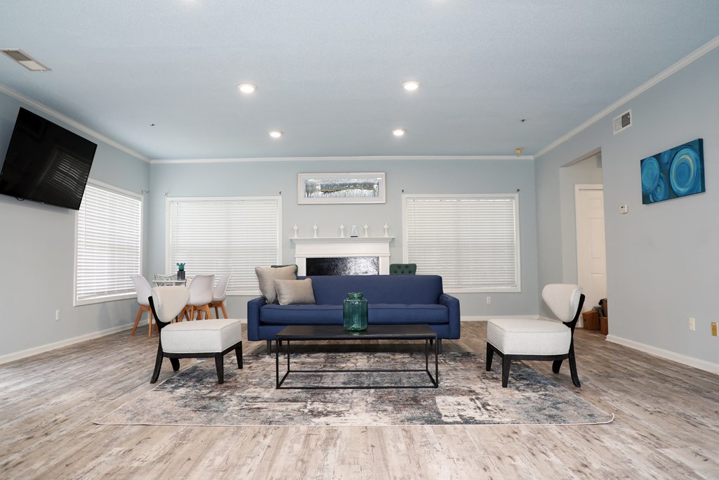 a living room with a couch and chairs and a fireplace