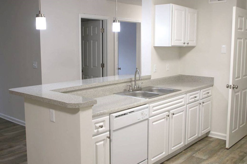 a kitchen with white cabinets and a sink