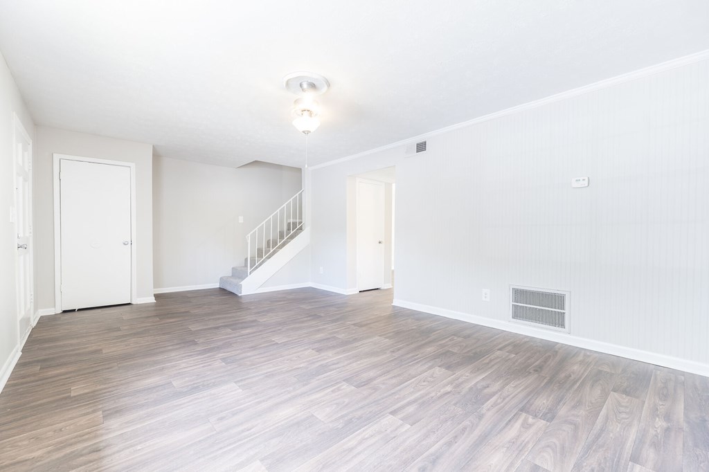 A room with a staircase and a door.