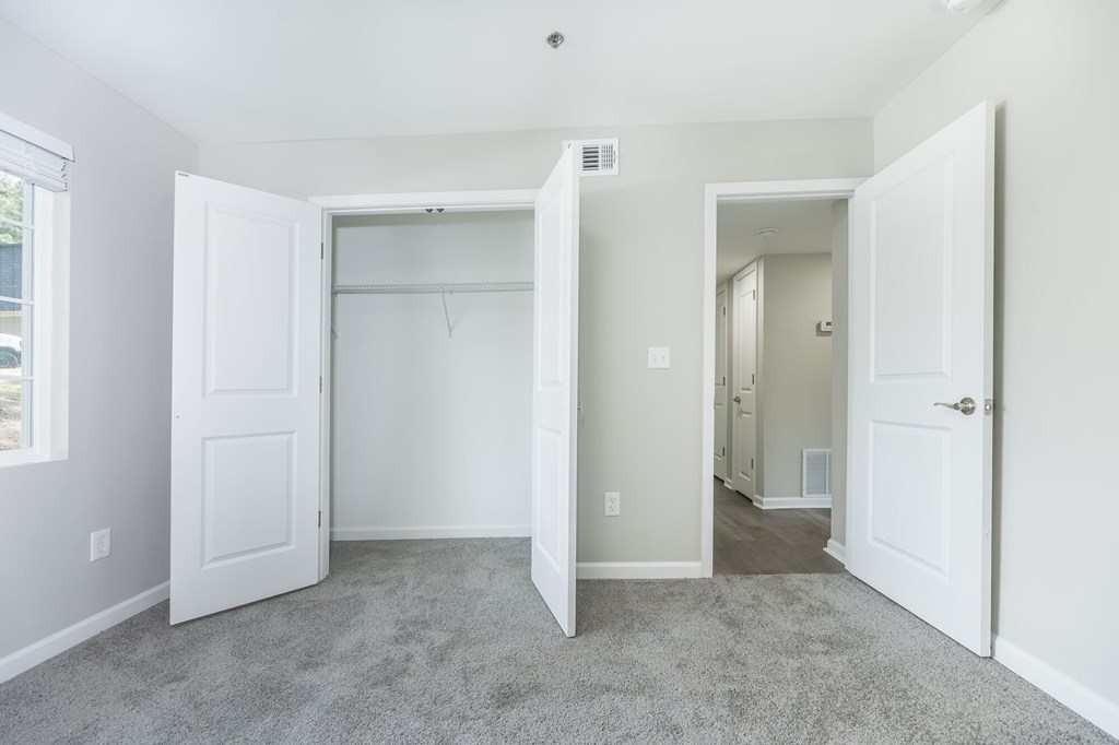 A room with a carpeted floor and white walls.
