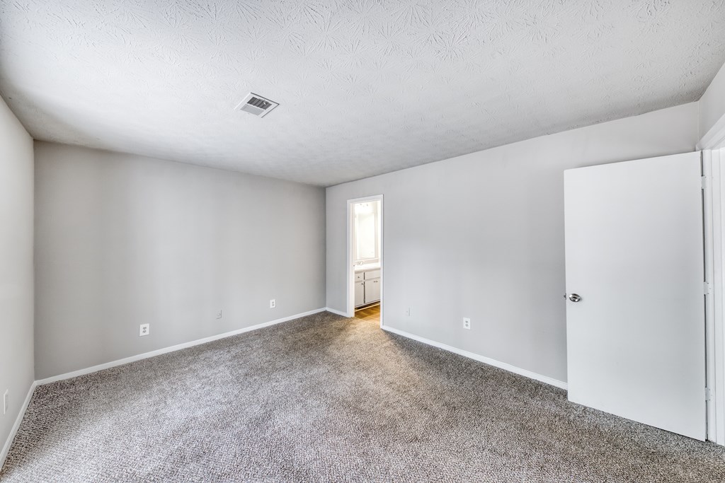 A room with a carpeted floor and white walls.