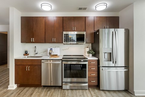 a kitchen with stainless steel appliances and wooden cabinets