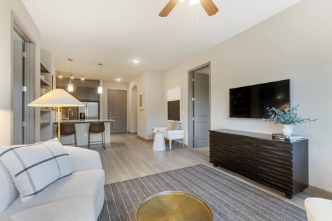 a living room filled with furniture and a flat screen tv