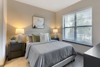 a bedroom with a bed and two night stands - Photo Gallery 3