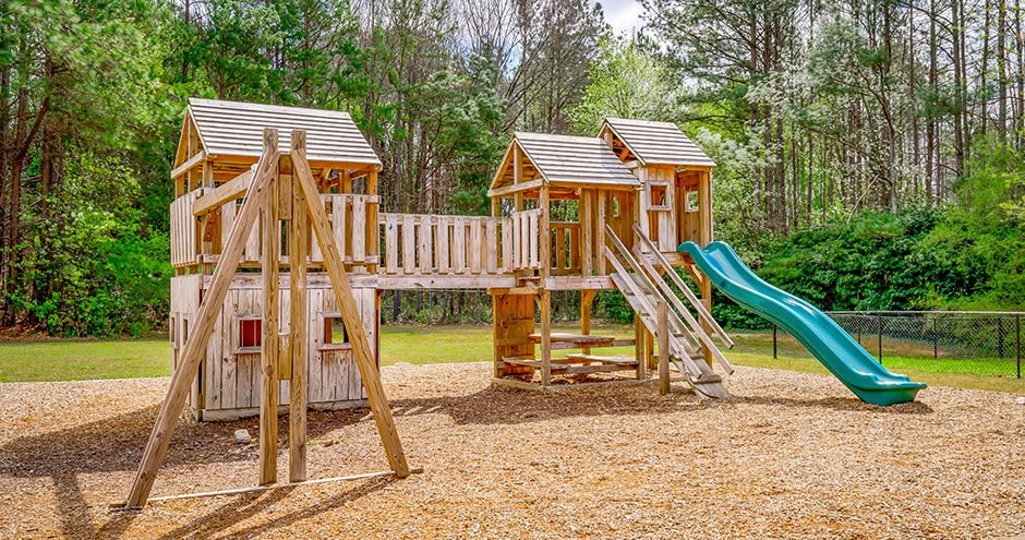 a playground with a swing set and a slide