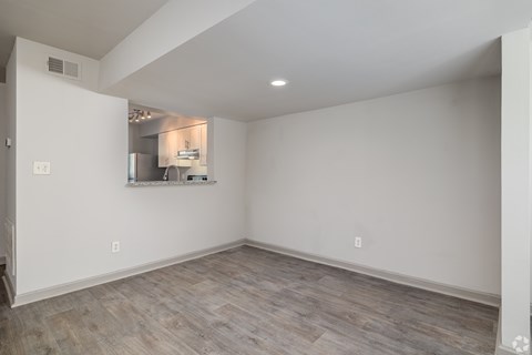 A room with a kitchenette in the corner.