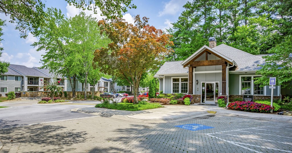 a parking lot in front of a building with trees