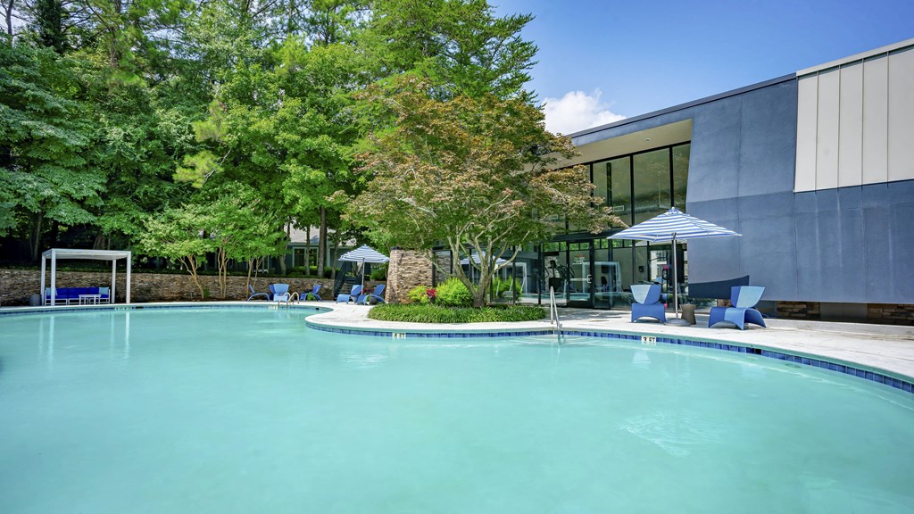 a swimming pool with a building in the background