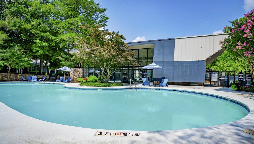 a large swimming pool in front of a building