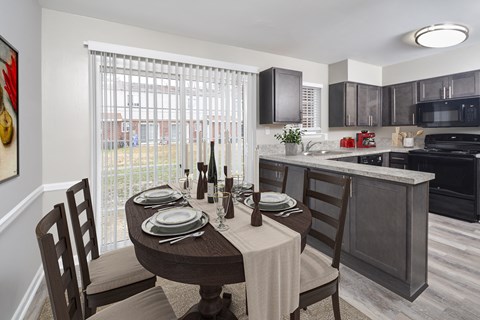an open kitchen and dining area with a table and chairs