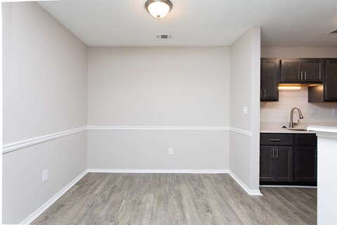 A kitchen with black cabinets and a white countertop.