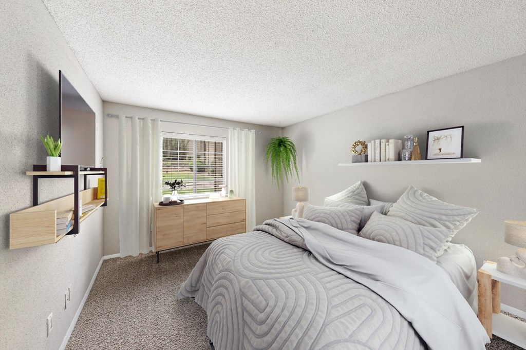 a bedroom with a large bed and a window