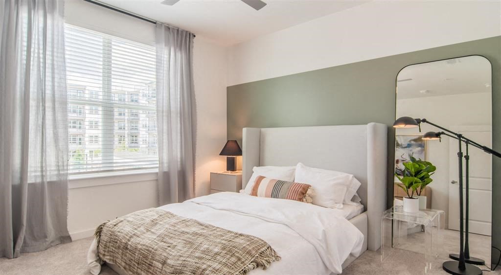 a bedroom with a bed and a mirror