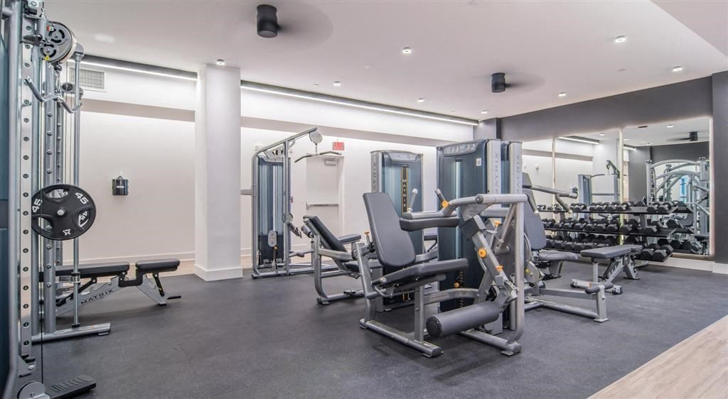 a gym with cardio equipment and weights in a building