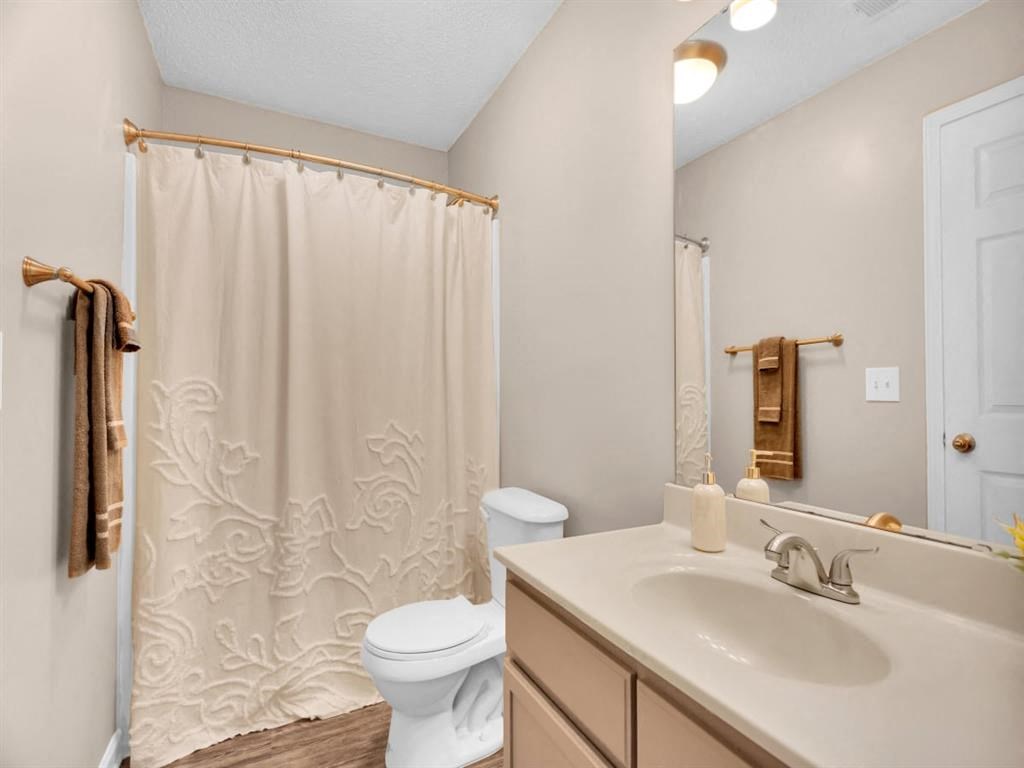 a bathroom with a shower and a sink and a toilet