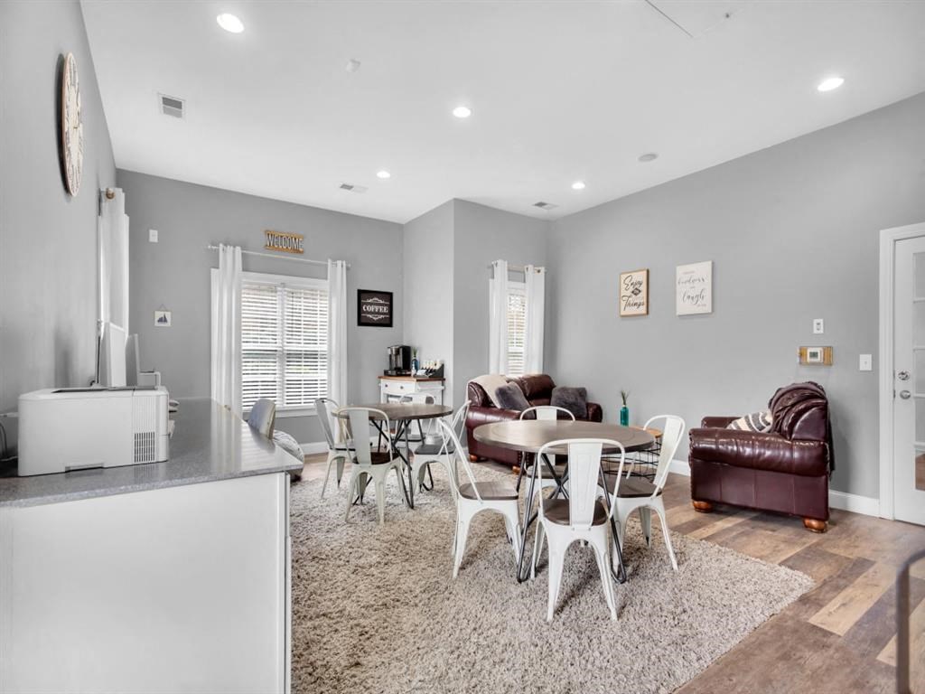 a living room with a table and chairs and a kitchen
