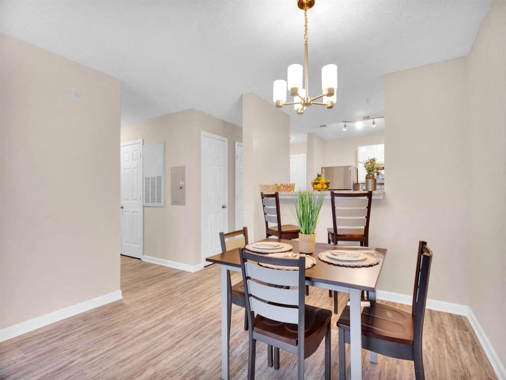 a dining room table with chairs and a chandelier