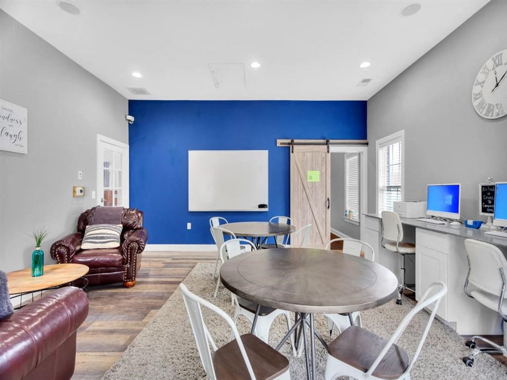 a living room with a blue accent wall and a round table