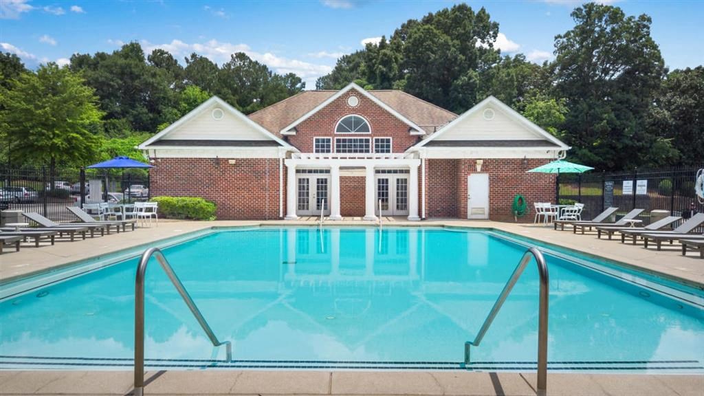 a swimming pool in front of a brick building