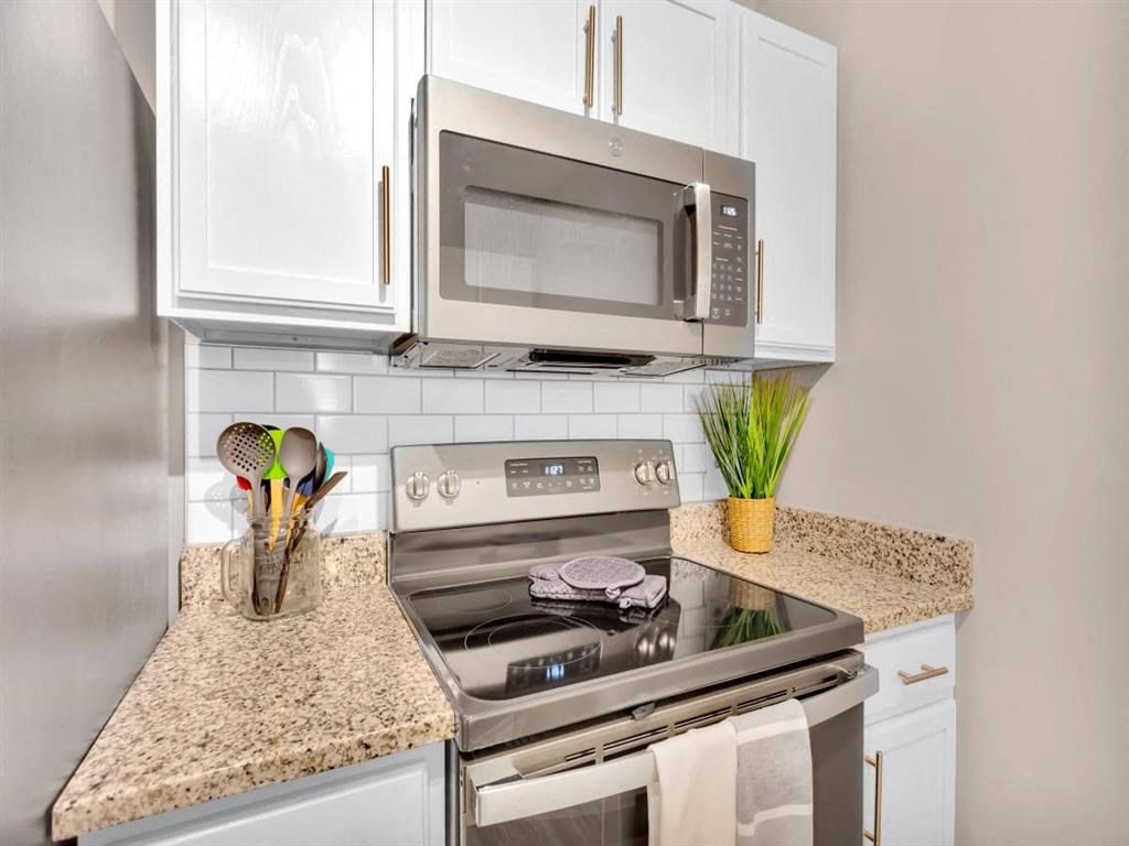 a kitchen with a stove and a microwave
