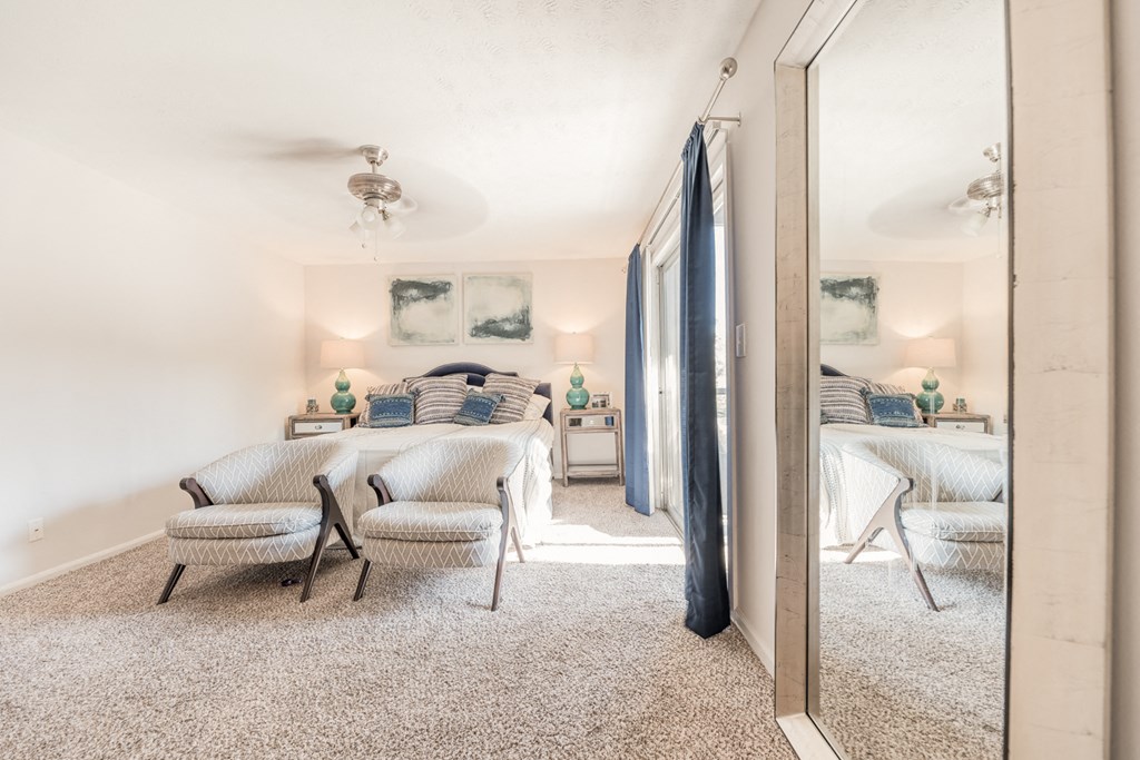 a bedroom with two beds and a mirror