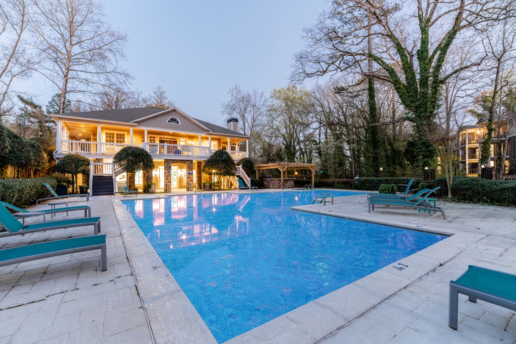 a swimming pool with a house in the background