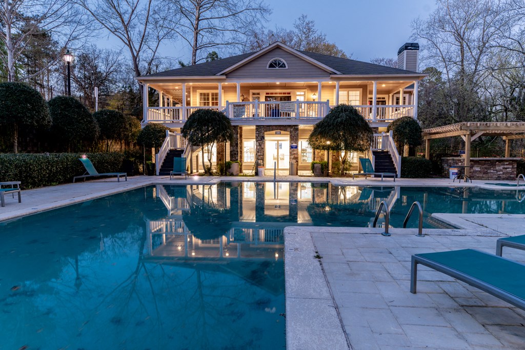 a large swimming pool in front of a house