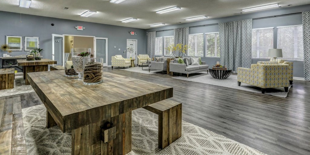a lobby with a wooden table and chairs