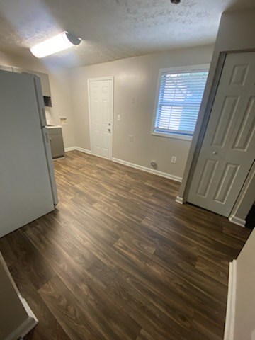A room with wood flooring and white walls.