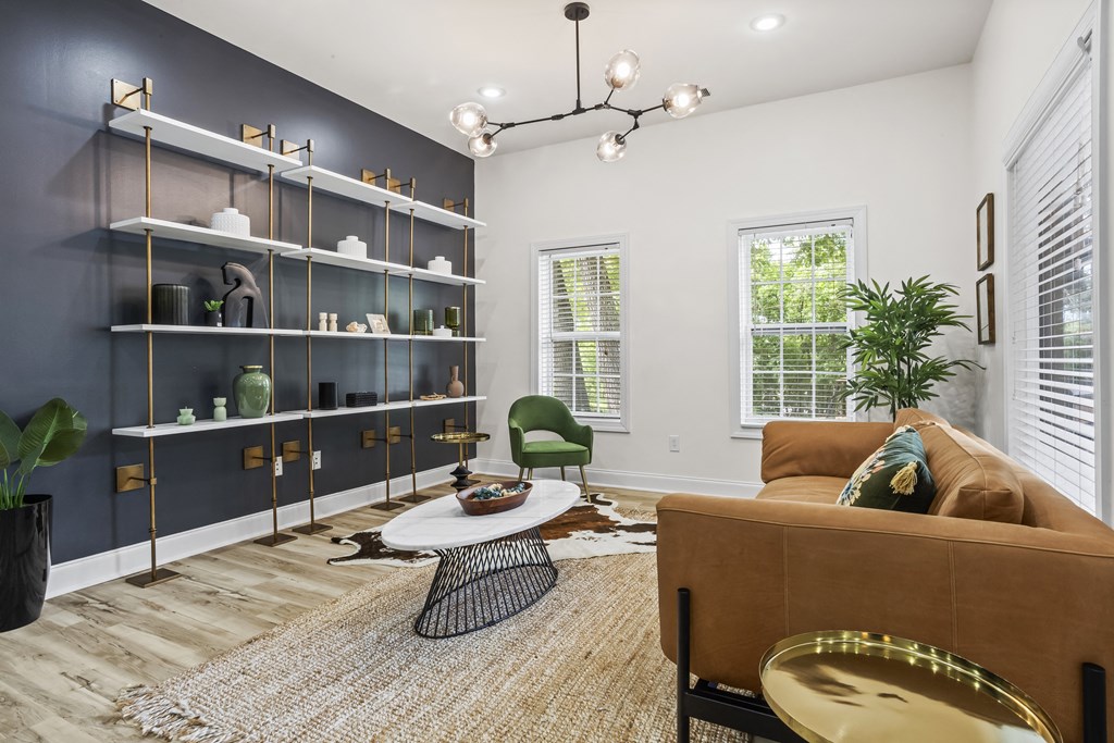 a living room with a brown couch and a book shelf