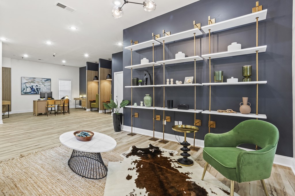 a living room with a green chair and a white table