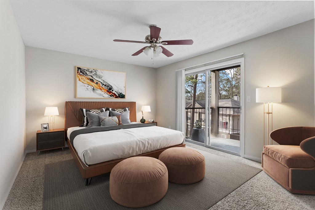 a bedroom with a large bed and a ceiling fan