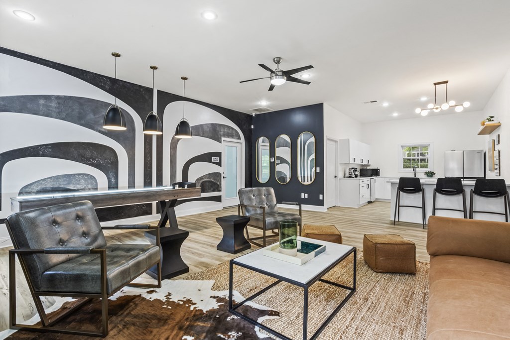 a living room with couches and chairs and a table