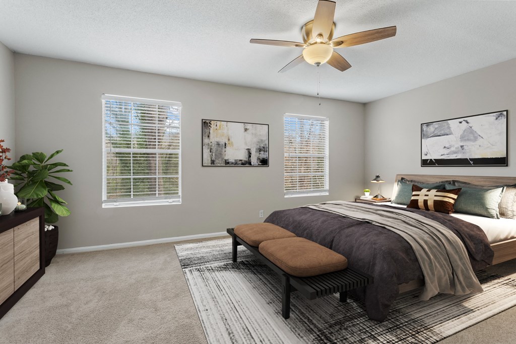 an expansive bedroom with a large bed and a ceiling fan