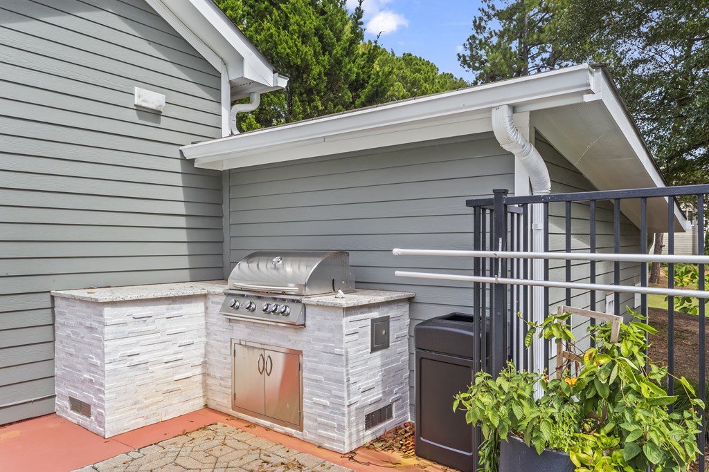 a backyard with a grill and a barbecue