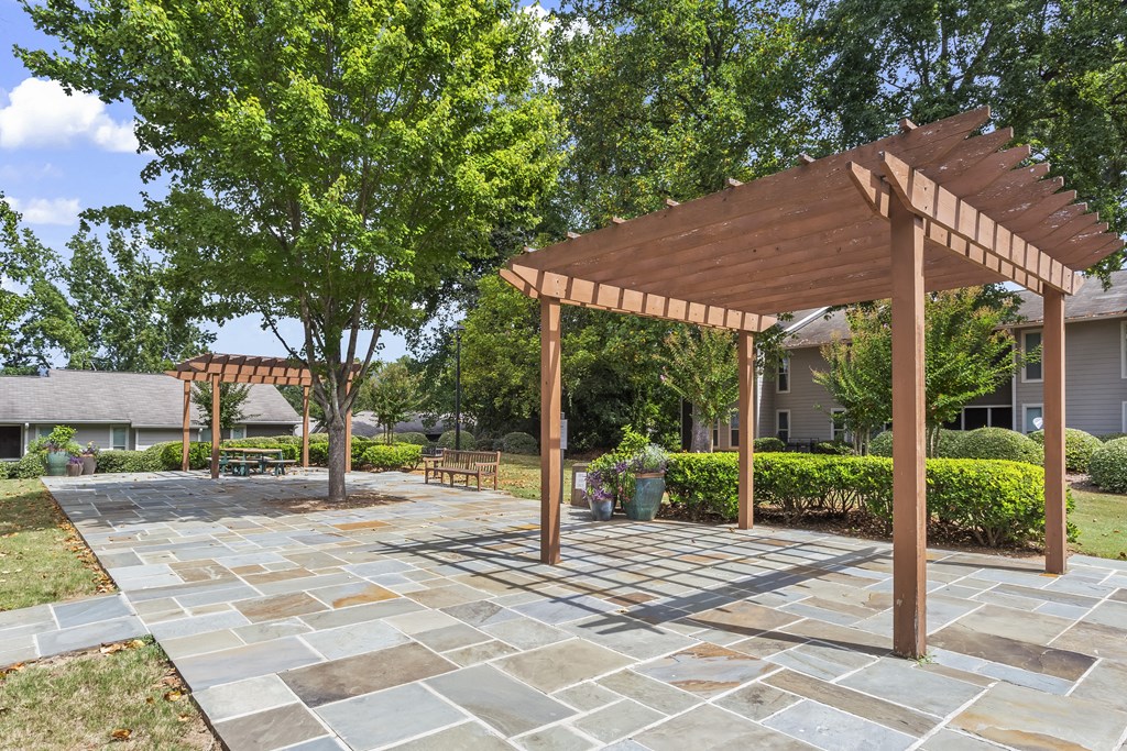a large patio with a wooden pergola