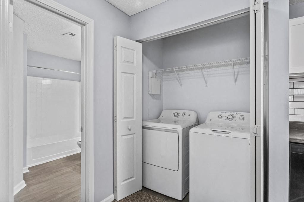 a white laundry room with white appliances and a white door
