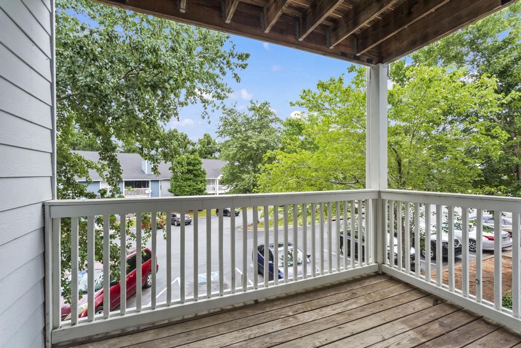 the view from the deck of a house with cars parked on it