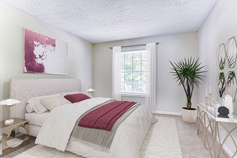 A bedroom with a large bed and a painting on the wall.