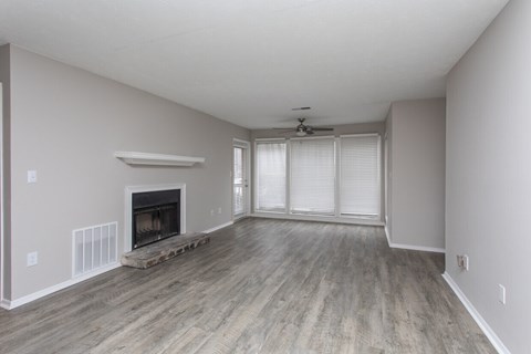 A spacious living room with a fireplace and sliding glass doors.